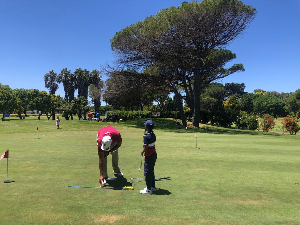Setting up a young golfer on the green
